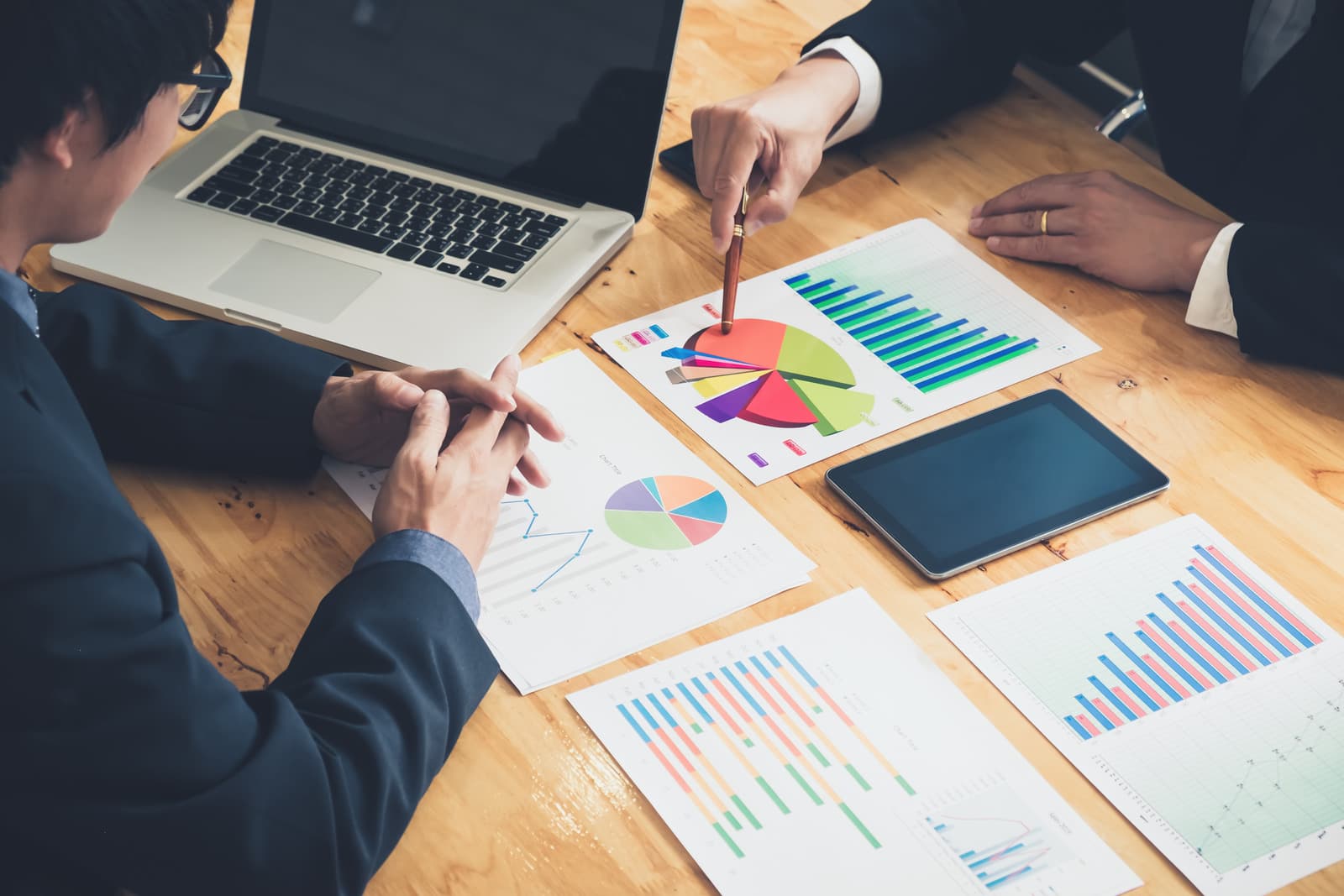 Business professionals analysing charts and data